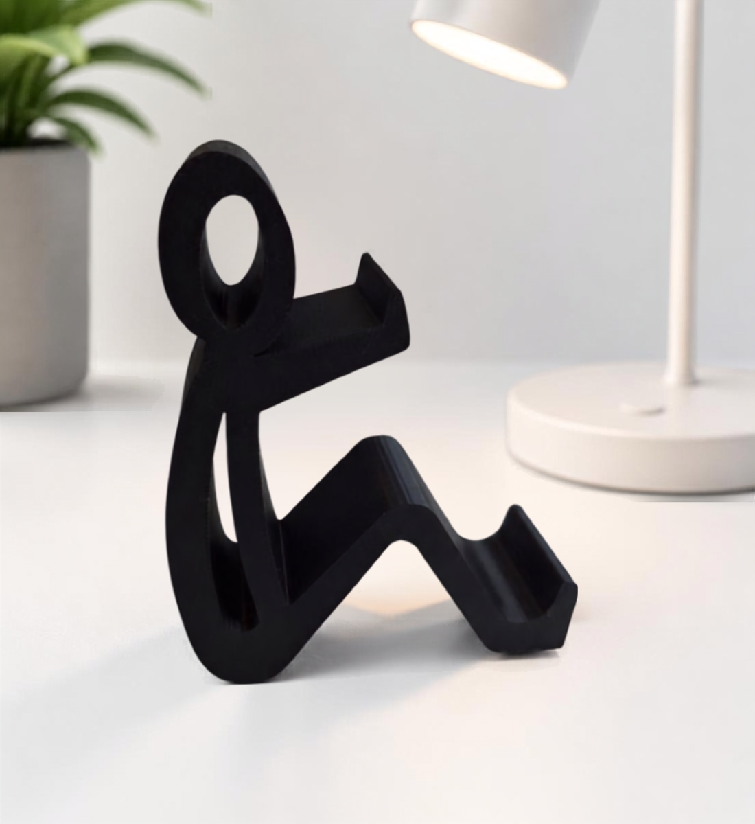 Het Zittend Mannetje – Telefoonhouder – Zwart